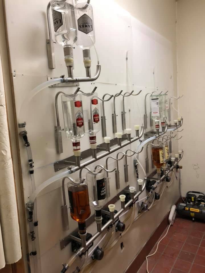 Liquor reserve room with wall-mounted dispensing lines