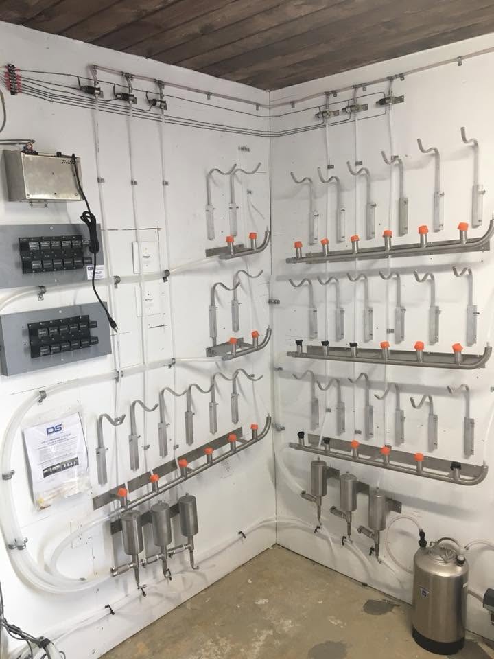 Wall-mounted precision liquor dispensing system with labeled bottles