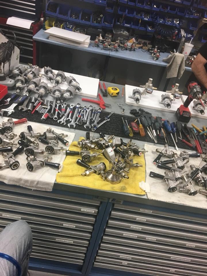 Tools and couplers laid out on a workbench mid-repair